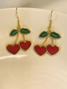 Adorable Earrings featuring heart-shaped cherry charms. The "fruit" themselves are red with green leaves and gold trim/stems. The red on these cherries is see-through and sparkly so they'll catch the light.  These cuties measure about 1in x 1.25in. The earring wires are hypoallergenic with a fishhook design. Clip-ons are available upon request. Cute Summer Vibes, Doctor Earrings, Cherry Jubilee, Cherry Earrings, Earring Wires, Bee Earrings, Drop Dead, Fit Ideas, Fancy Outfits