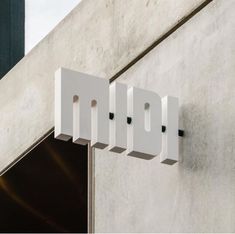 the letters mpp are mounted to the side of a building's exterior wall