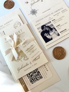 the wedding stationery is laid out on top of the table next to an unidentifiable coin