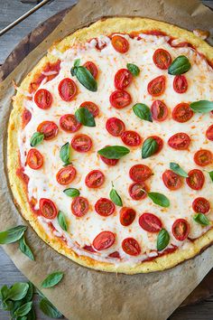 a pizza with tomatoes and basil on it