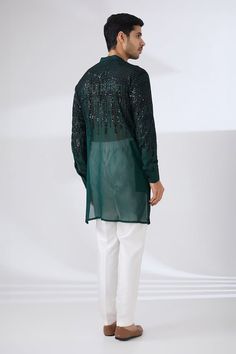 Dark green georgette kurta with all over sequin and thread embroidery. Paired with a white pant. - Aza Fashions Navratri Party Wear Kurta With Resham Embroidery, Festive Party Wear Kurta With Sequins, Green Sequined Traditional Wear For Eid, Traditional Green Sequined Wear, Designer Georgette Kurta With Sequins, Designer Georgette Sequin Kurta, Eid Georgette Kurta With Sequins, Long Sleeve Georgette Salwar Kameez With Sequins, Green Traditional Wear With Sequins For Navratri