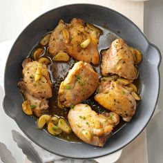 a pan filled with chicken and vegetables on top of a table