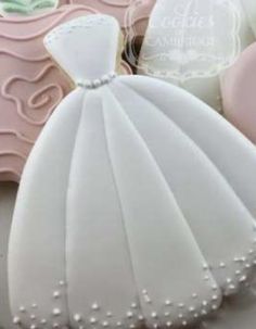 some cookies that are shaped like wedding gowns