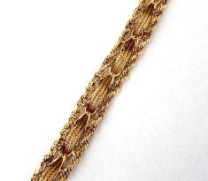 Picture is worth a thousand words,this beautiful 14k solid yellow gold bracelet with intriguing wave and twisted rope chain borders,slide in clasp and safety catch ,weight is 18.4 grams . Height is 1/2 inch,thickness 3 mm,total length from end to end is 8 inches,less 5/16 when closed. Condition like new ,a high quality piece. #729 Elegant Gold Rope Chain Bracelet For Formal Occasions, Elegant Formal Gold Rope Chain Bracelet, Formal Yellow Gold Rope Chain Bracelet, Elegant Bracelets With Rope Chain And Link Shape, Elegant Bracelets With Link Rope Chain, Elegant Rope Chain Link Bracelets, Elegant Bracelets With Rope Chain Link, Elegant Gold Bracelet With Rope Chain, Formal Rope Chain Bracelet Jewelry