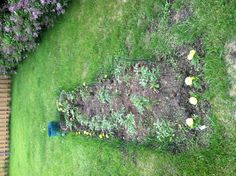 the garden is ready to be planted and put into the ground by the fenced in area