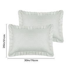 two white pillows with ruffled edges