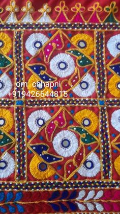 an embroidered cloth with different colors and designs on the fabric is shown in this image