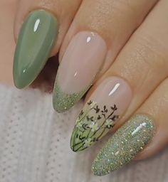 a woman's nails with green and white designs on them