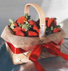 a basket filled with strawberries on top of a table