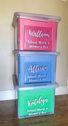 three plastic storage containers sitting on top of a hard wood floor next to a wall