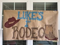 a banner that says luke's 1st rodeo with cowboy boots and hats on it