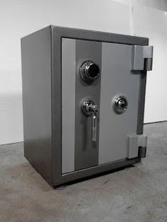 a large metal safe with two keys on it