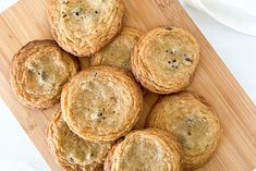 a bunch of cookies sitting on top of a wooden cutting board