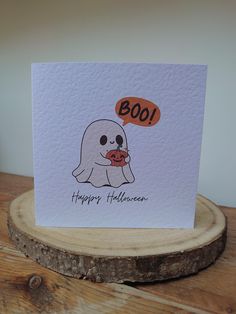 a greeting card with a ghost holding a hot dog in it's mouth saying boo happy halloween