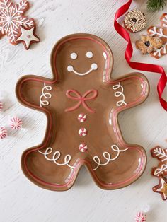 a decorated gingerbread cookie sitting on top of a white table