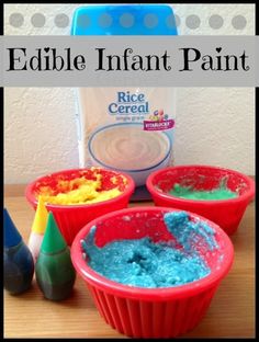 three red bowls with blue, green and yellow food in them next to a bottle of edible infant paint