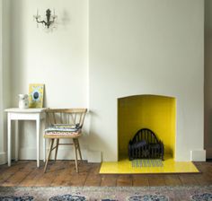 a living room with a fire place next to a chair