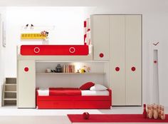 a red and white bedroom with bunk bed, desk and bookshelf in the corner