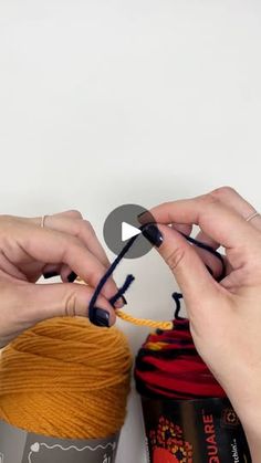 two hands crocheting together yarn on top of each other and another hand holding the yarn