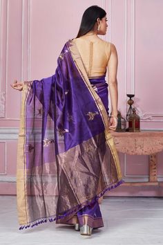 Beautiful purple Banarasi saree with golden zari border is a perfect choice for festive occasions. It has zari motifs and comes with a matching blouse piece. Disclaimer: The shown stitched blouse on the model is for display purpose only. The saree comes with a matching blouse piece and finished with fall and piko. Purple Banarasi Saree, Banarasi Sari, Latest Designer Sarees, Fashion Journals, Banarasi Saree, Traditional Fabric, Designer Sarees, Banarasi Sarees, Blouse Dress