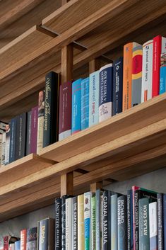 several books on wooden shelves in a library