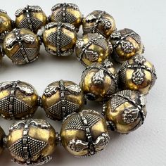 One handmade Kazakh style turkoman silver bead on brass. No two are exactly alike - hand fabricated. Lightweight gorgeous bead made in a very old tradition for an ethnic tribal look. So lightweight, we love the bigger bold look without the heavy weight.  One bead 25x19 approximately 3.5mm hole. Handmade Bohemian Brass Beads, Artisan Handmade Beads For Festive Occasions, Gold Festival Jewelry With Metal Beads, Artisan Handmade Festive Beads, Bohemian Round Beads For Festivals, Antique Gold Beaded Jewelry With Round Beads, Antique Large Gold Beads, Bronze Brass Jewelry With Large Beads, Traditional Handmade Beads For Jewelry Making