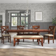 a dining room table with bench and chairs