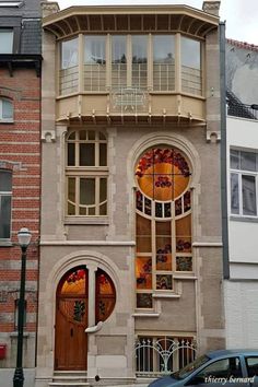 an old building with stained glass windows on the front