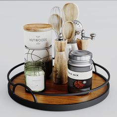 a wooden tray topped with jars and spoons on top of a metal rack filled with wood utensils