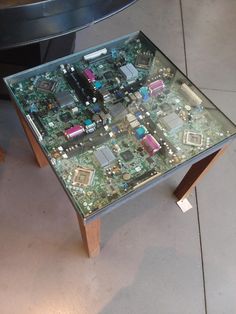 a computer motherboard sitting on top of a glass table