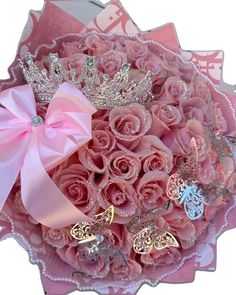 a bouquet of pink roses with tiaras on it