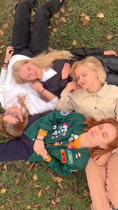 three women laying on the ground with their arms around each other