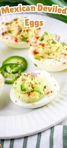 mexican deviled eggs on a plate with peppers and jalapenos in the background