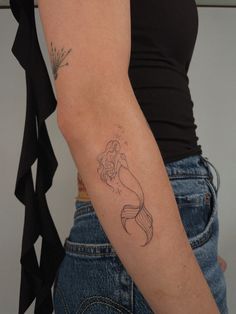 a woman with a tattoo on her arm