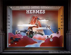 a store window with an advertisement for hermes