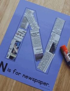 the letter n is for newspaper next to a crayon marker and some paper