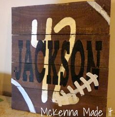 a wooden sign with the word jackson painted on it's side in white and brown