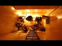 several people are climbing up the side of a ladder in a room with yellow walls