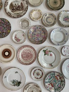 there are many plates on the wall and one is full of them all have different designs