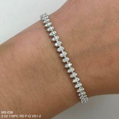 This exquisite 2.02 Pear Shape Diamonds Illusion Tennis Bracelet is crafted in glistening 14k White Gold. Each diamond is carefully set in a shared prong setting, allowing for maximum sparkle and brilliance. The streams of diamonds are sure to make a dazzling impression. 2.02 TCW F G VS1-2 118 ROUND DIAM 14 K W/GOLD 6.41 GRAMS MS-038 Pear Shaped Tennis Bracelet, Pear Shape Diamond Bracelet, Pear Shaped Diamond, Tennis Bracelet, Pear Shape, Pear Shaped, Prong Setting, Diamond Bracelet, Natural Diamonds