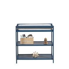 a blue shelf with two shelves and a baby's crib next to it