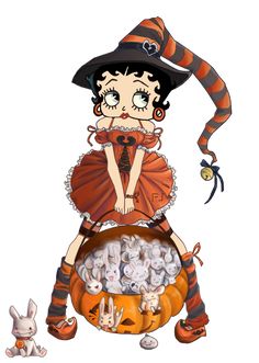 a woman in a witch costume sitting on top of a pumpkin