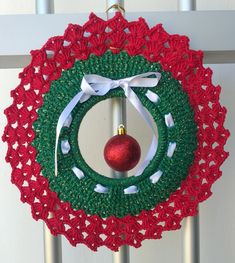 a crocheted christmas ornament hanging from a door