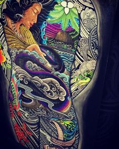 a woman's back with colorful tattoos on her body and an image of a dragon