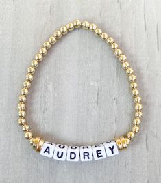 Gold Name Bracelet ✨✨ Made with 18k gold filled beads so your bracelet won't tarnish ✨✨ Get your name, your last name, your kids names or whatever you want. This little cute bracelet goes with any stack and looks good by itself ✨ Made with 18k gold filled round beads and 4mm square letters **Also available in Silver and Rose Gold** Please put name or word in Personalization Section* CARING TIPS FOR YOUR JEWELRY ⭐️Treat and store with care. ⭐️ For longevity, avoid exposing your jewelry to water. ⭐️ Avoid having direct contact with lotions, perfumes, sanitizers as these chemicals may cause discoloration of your jewelry. Gold Letter Beads Charm Bracelet For Friendship, Gold Charm Bracelet With Letter Beads For Friendship, Gold Jewelry With Letter Beads For Friendship, Gold Jubilee Bracelet For Friendship, Gold Stretch Bangle With Letter Beads, Gold Stretch Bangle Bracelet With Letter Beads, Adjustable Gold Jubilee Name Bracelet, Adjustable Hypoallergenic Yellow Gold Stretch Bracelet, Letter Beads Bangle Jewelry Gift