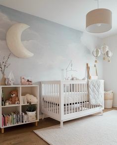 a baby's room with a crib, bookshelf and stuffed animals