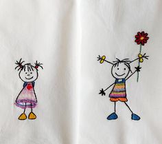 two embroidered children's towels with one holding a flower and the other wearing an apron