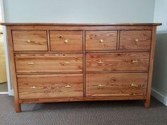 a large wooden dresser sitting in a room next to a wall and carpeted floor