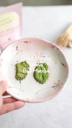 a person holding a white bowl with green powder in it and the words good match written on it