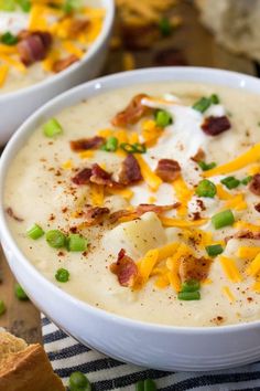 two bowls of potato soup with bacon and cheese